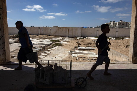 Palestinians make graves from the rubble of Gaza's destroyed homes