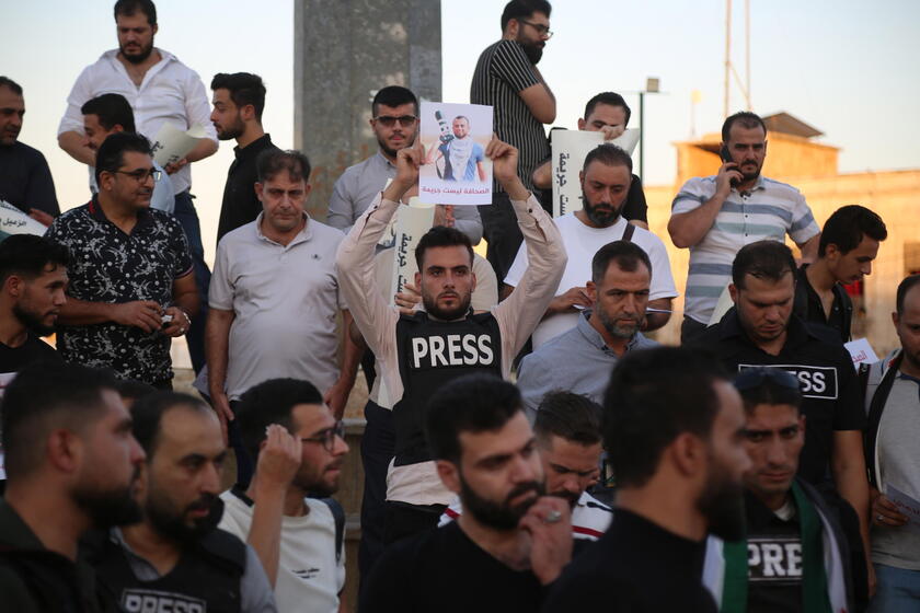 Syrian journalists protest after a colleague was arrested in northern Syria